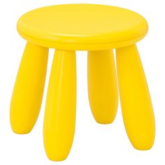 a yellow stool with three legs on top of each one, sitting in front of a white background