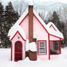 a red and white house with snow on the roof