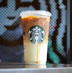 a cup of iced coffee sitting on top of a counter