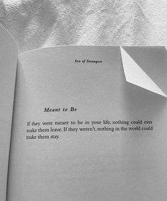 an open book with a piece of paper sticking out of it's center and the words meant to be