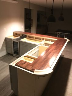 an empty kitchen with wooden counter tops