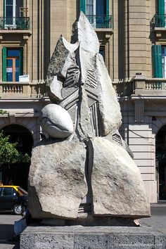 a large stone statue in front of a building