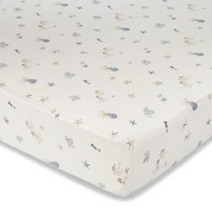 an image of a baby crib sheet with stars and sea animals on it's side