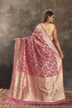 Be vision of elegance on special occasions in this gorgeous onion pink tussar Banarasi saree. It enhanced with floral golden zari jaal and pallu. It comes with a matching blouse piece. Disclaimer: The shown stitched blouse on the model is for display purpose only. The saree comes with a matching blouse piece and finished with fall and piko. The actual product may vary slightly from the image. These are custom orders, hence expect slight variation in color, placement of the motif or buta. ESTIMAT Onion Pink, Sarees Banarasi, Embroidered Sarees, Fashion Journals, Traditional Fabric, Banarasi Saree, Indian Saree, Saree Online, Georgette Sarees