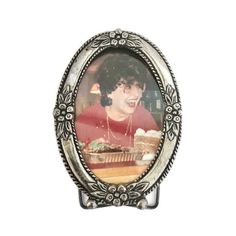 an old fashioned photo frame with a woman in red shirt and pearls on the bottom