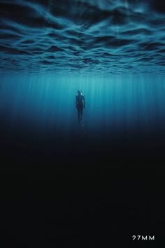 a man is swimming in the ocean under water