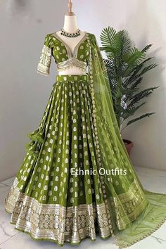 Welcome to ethnic outfits. As a dedicated small business, we are thrilled to share our passion for handcrafted ethnic wear with you. From the moment you place an order, we take care of every detail, ensuring a seamless experience from start to finish. We carefully source premium fabrics and handle all the embroidery in-house, combining both machine and intricate handwork. Our expertise also extends to printing, beading, and adding stunning embellishments like stones, mirrors, and more. Each piece is crafted with precision and care, ensuring it meets our highest standards of quality and elegance. We only start making the outfit after confirming your customized size details. Handling time: No need to worry, simply let us know your preferred delivery date, and we will ensure the order is proc Mehendi Green Outfits, Reception Choli With Gota Work In Banarasi Silk, Banarasi Silk Choli With Gota Work For Reception, Transitional Green Lehenga With Gota Work, Reception Banarasi Silk Choli With Gota Work, Pista Green Lehenga With Gota Work For Wedding, Banarasi Silk Choli For Eid Reception, Fitted Lehenga With Gota Work In Anarkali Style, Semi-stitched Pista Green Choli With Gota Work