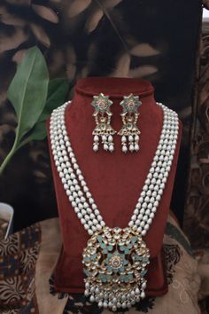 Turquoise Gold Plated Meenakari and Pearl Necklace. This regal Necklace Set is based on material of copper alloy. The four pearl strands end into a beautiful work of meenakari in an intricate floral pattern. the floral pattern is embellished with kundan and pearls ending into a waterfall of pearls. The piece is plated with 22k gold. This beauty is a must in your traditional jewelry collection. LENGTH Necklace Size - 26 inches. Closure - Adjustable Dori. Earring Size- 6 cm DETAILS -100% top Quali Festive Turquoise Necklace For Gifts, Temple Jewelry Turquoise Necklaces For Festivals, Turquoise Temple Jewelry Necklaces For Festivals, Turquoise Kundan Necklace Temple Jewelry Gift, Temple Jewelry In Turquoise For Festivals, Traditional Turquoise Bridal Necklace As A Gift, Traditional Turquoise Jewelry Sets As Gift, Turquoise Jewelry For Diwali Gift, Blue Meenakari Chandbali Necklace