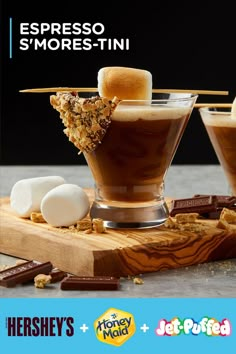 two desserts with marshmallows and chocolate on a wooden cutting board next to the words, espresso smorestini