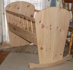 a wooden bed frame sitting on top of a carpeted floor next to a rocking chair