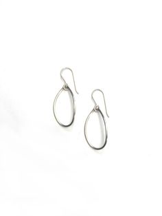 These simple wire teardrop earrings are perfect for every day. Handmade in the US and available in black steel, bronze, or silver. The classic design makes them perfect to throw on with everything - I've worn them as often with yoga clothes to run errands as I have with statement pieces like the Maya necklace. Available in steel with silver ear wires, steel with 14-kt gold-filled ear wires, sterling silver, or bronze with 14-kt gold-filled ear wires. Each earring is approximately 1 1/2" long. Comes packaged in a gift box - the perfect treat for yourself or a loved one! Black Steel, Yoga Clothes, Teardrop Earrings, Ear Wires, Sterling Silver Earrings, Statement Pieces, Classic Design, Gold Filled, Gift Box