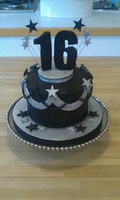 a black and silver cake with stars on it