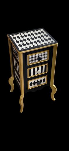 a black and white checkered table with gold trimmings on the top, sitting in front of a black background