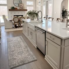 a large kitchen with an island in the middle and lots of counter space around it