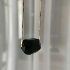 Made with beautiful black obsidian gemstone, this necklace is not only stylish but also has a meaning. Obsidian is known as a stone of protection, helping to shield you from negativity. It's also said to promote strength and courage, two qualities that we could all use more of in our lives. So not only will you look great wearing this black obsidian necklace, but you'll also feel great knowing that you're wearing something with such positive energy. Whether you're treating yourself or someone else, Black Obsidian Necklace makes for a perfect gift.

 	Size: 18 inches
 	Free Shipping 2 Days
 	Authentic Stone Black Obsidian Black Obsidian Necklace Gift, Black Obsidian Necklace For Gift, Modern Black Necklace With Adjustable Chain, Black Obsidian Necklaces For Meditation, Black Obsidian Necklace For Meditation, Black Natural Stones Pendant Necklace, Black Natural Stone Pendant Necklaces, Black Faceted Jewelry As A Gift, Black Pendant Necklaces With Natural Stones