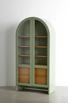 a green bookcase with two wooden drawers