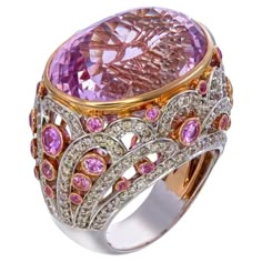 In the world of fine jewelry, there are creations that stand out not only for their sheer beauty but also for the stories they tell and the emotions they evoke. The 35.15-carat Oval Kunzite, 1.95-carat Pink Sapphire, and 1.83-carat White Diamond Queenly Ring is a masterpiece that embodies the very essence of timeless elegance and sophistication. Crafted with an unwavering commitment to excellence, this extraordinary ring is a celebration of nature's most captivating gems. At its heart lies a mes Luxury Iridescent Cabochon Rings, Luxury Oval Kunzite Jewelry, Fantasy Jewelry Magic, Kunzite Ring, Ring Aesthetic, High Jewelry Ring, Purple Diamond, Colorful Accessories, Oval Ring