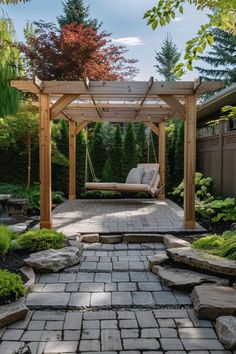 a patio with a swing chair and stone walkway