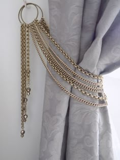 a curtain with gold chains hanging from it's side