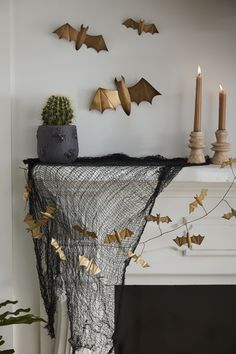 a mantle with candles and decorations on it