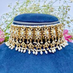 Featuring a classic broad pearl choker necklace matched with a magnificient pair of edwardian era style earrings, made in sterling silver with 22K gold plating. Ideal for wedding functions and will go with any south asian attire. It has been embellished with freshwater pearls. Weight - 110 GMs for the full set with earrings weighing 30gms Default Materials in Our Gold Plated Jewellery Metal: 925 Sterling Silver Studded Stones: Precious freshwater pearls, synthetic red,green,blue stones that rese Elegant Wedding Choker For Festivals, Formal Kundan Choker With Intricate Design, Elegant Kundan Choker Necklace With Tilla, Elegant Kundan Choker Necklace For Ceremonial Occasion, Luxury Gold Pearl Necklace For Wedding, Formal Bridal Choker With Tilla, Elegant Festive Ceremonial Choker, Elegant Festive Choker With Intricate Design, Elegant Kundan Bridal Choker Necklace