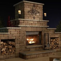 an outdoor fireplace is lit with candles