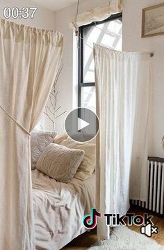 a white bed sitting under a window next to a radiator