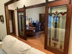 a living room filled with furniture and stained glass doors