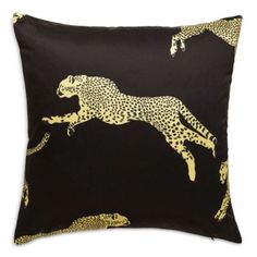 a black and gold pillow with a cheetah on it