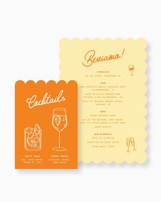 an orange and yellow menu with a glass of wine on the front, and a card that says cocktail