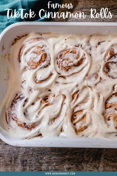 a pan filled with cinnamon rolls covered in icing