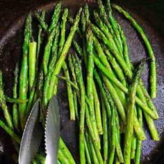 the asparagus are ready to be cooked in the skillet with tongs