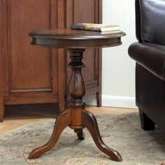 a small wooden table sitting on top of a rug