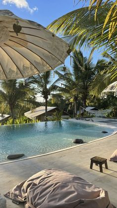 an open umbrella next to a swimming pool