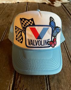 Experience unique style and comfort with our Race Cars & Butterflies Hat! Made by Wild Plains, this Sky Blue/White Foam Trucker Hat features a mesh back and a snap closure for a perfect fit. Adorned with Valvoline, butterfly, and race flag patches, this one-of-a-kind hat will make you stand out from the crowd. Features: Sky Blue/White foam trucker hat Mesh back Snap closure Patches Include: Valvoline Butterflies Race Flags One of a kind Made by Wild Plains ALL SALES ARE FINAL ON ONE OF A KIND TR Vintage White Trucker Hat For Spring, Blue Snapback Hat With Short Brim For Summer, Blue Summer Snapback Hat With Short Brim, Casual Mesh Hat For Spring, Retro Trucker Hat With Short Brim For Spring, Retro Trucker Hat With Curved Brim For Spring, White Retro Trucker Hat For Spring, Retro White Trucker Hat For Spring, Vintage White Trucker Hat For Summer