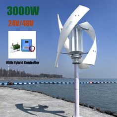 a white wind turbine next to the water