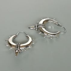 A PAIR of chunky ethnic style sterling silver spike hoops. Dimensions: Length (with spike) 33mm Width: (with spike) 25 mm Weight: 10.8 gm Price listed is for a PAIR of hoops. These earrings are made of 925 hypoallergenic sterling silver Can be packaged in a gift box. I can include a personal message from you if needed You are welcome to contact me at... bhavnakwintra1956@gmail.com For more beautiful pieces from my shop, please browse 👇 TOE RINGS: https://www.etsy.com/your/shops/TheSilverGame/to Punk Style Small Hoop Pierced Jewelry, Nickel Free Punk Earrings For Festivals, Nickel-free Punk Earrings For Festivals, Edgy Silver Earrings For Festival, Punk Small Hoop Metal Jewelry, Punk Style Small Hoop Metal Jewelry, Punk Style Pierced Round Jewelry, Silver Gothic Plug Earrings For Festival, Silver Hoop Punk Piercings