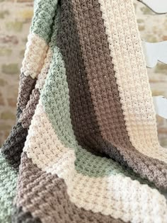 a crocheted blanket sitting on top of a chair