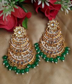 Shine like a glowing star in this high quality gold toned Kundan earrings lined with fine lustrous pearls.Pair them up with your silks and satins add charm and charisma to your beautiful personality Earrings length 4 inches Width 2.3 inches Weight 84 gm Keep your precious Kundan jewelry away from perfume,spray and water.Keep it away from direct heat, water, perfumes, deodorants and other strong chemicals as they may react with the metal or plating.The plating composition of Jewellery is as such Festive Bridal Earrings With Cutdana, Elegant Kundan Necklace With Dori Work For Festive Occasions, Traditional Pearl Earrings For Festive Celebrations, Traditional Green Pearl Earrings For Festivals, Festive Gold Pearl Earrings, Festive Elegant Bridal Earrings With Gota Work, Festive Bridal Earrings With Cutdana For Celebration, Festive Gift Pearl Earrings, Festive Bridal Cutdana Earrings For Celebrations