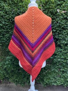 Beautiful colors in this shawl! Crocheted in very soft wool mix yarn Wear as a shawl or triangle scarf Wear around your shoulders or with a belt Measures approx 58" across x 32" top to bottom Orange Bohemian Shawl For Fall, Orange Shawl Scarves For Fall, Orange Shawl Scarf For Fall, Orange Shawl Scarves For Winter, Multicolor Semi-stitched Shawl For Festivals, Purple Festival Shawl, One Size Multicolor Shawl Scarf, Orange Winter Shawl Scarf, Purple Shawl