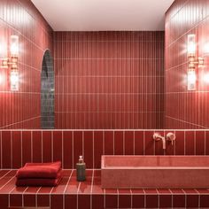 a red tiled bathroom with two sinks and mirrors