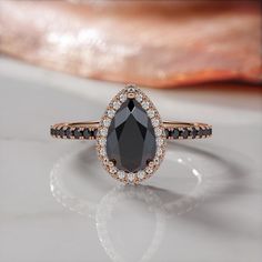 a black and white diamond ring on top of a table