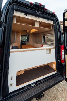 the back end of a van with its doors open and it's cargo compartment opened