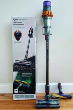 the dyson vacuum is next to its box