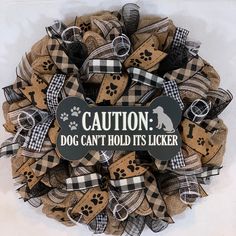 a wreath that says caution dog can't hold it's licker on the front