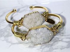 Perfect gifts for moms, birthdays, graduations and especially bridesmaids gifts!  My  unique handcrafted bracelets are the perfect accessory to any outfit.  These can be worn alone, but in my book, the more, the merrier!   *Natural Druzy gemstone  *18k Gold plated cuff *Wire wrap All my bracelets will have a slight variation due to the unique nature of the gemstones, so no two bracelets are ever 100% alike!   Each bracelet comes in its own pouch.  Great for keeping them in a safe and secure place, especially when traveling! Thank you for supporting a mom and her dreams ;) Follow me on Instagram and say hi @ instagram.com/samandgracejewelry Bohemian Cuff Bracelet For Weddings, Bohemian Gold Bracelets For Wedding, Bohemian Wedding Cuff Bracelet, Chic Handmade Bracelets As Gift, Bohemian Gold Bangle For Wedding, Gold Oyster Bracelet Jewelry For Wedding, Handmade Chic Bracelet Jewelry, Handmade Bohemian Cuff Bracelet For Wedding, Handmade Bohemian Wedding Bracelets