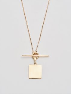 The must-have layer. Crafted from reclaimed 14Kt gold that’s gone through a refining process, the toggle necklace with its unique square ID tag simple yet striking. Style it with chains of different girths and length for a lustrous layered look. 14Kt Yellow Gold ID and Toggle Necklace ID Tag: 12 X 13.5mm Chain: 0.5mm Toggle Closure: 15mm Available in 16” or 18” Lengths Assembled in L.A. Globally Sourced Materials Square Tag Necklace, Quadrafoil Necklace, Toggle Necklace, Main Attraction, Pearl Gemstone, Shiny Things, Pure Gold, Id Tag, Silver Pearls