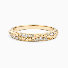 a yellow gold band with diamonds on the sides and an intricate design in the middle