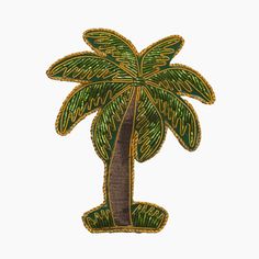 a palm tree embroidered on a white background