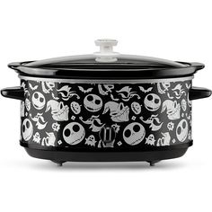 a black and white crock pot with skulls on it